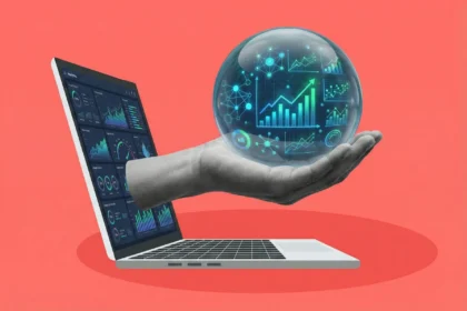 A grayscale hand emerging from a laptop screen, holding a glowing sphere of data visualizations to represent growth marketing predictive modeling on a coral red background.